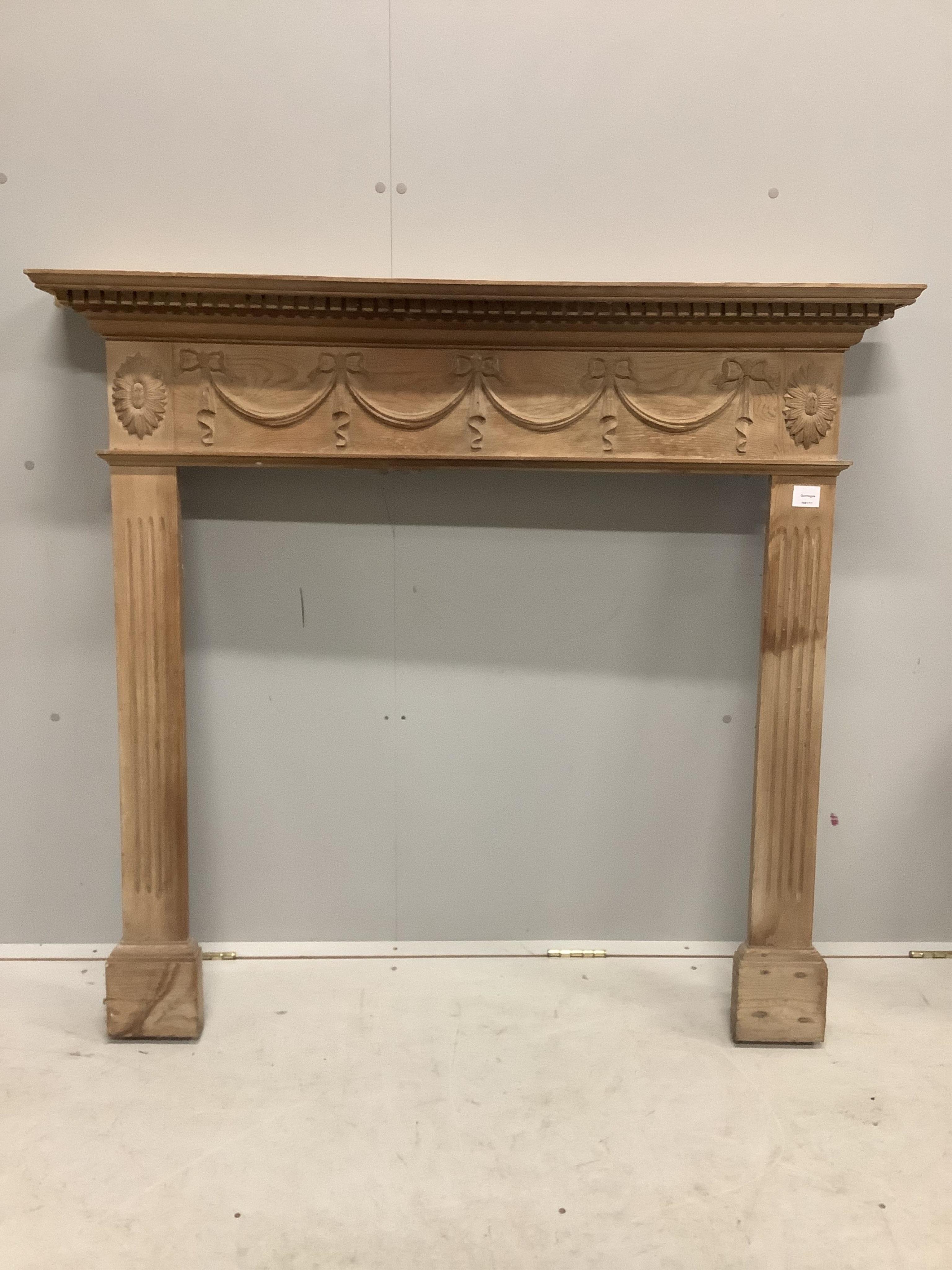 An Adam design pine fire surround, width 128cm, height 118cm. Condition - fair to good